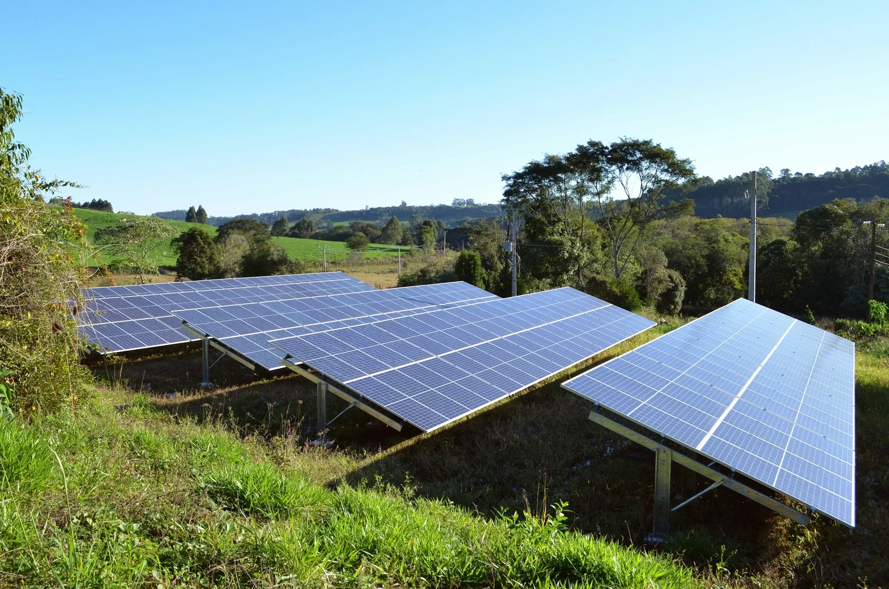 Solar panels across a green field